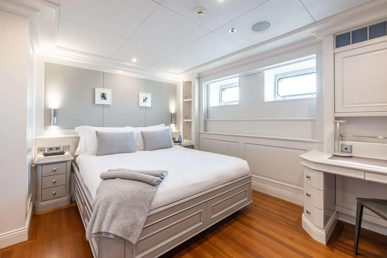 a bedroom with a bed and a desk aboard BRAVADO Yacht for Sale
