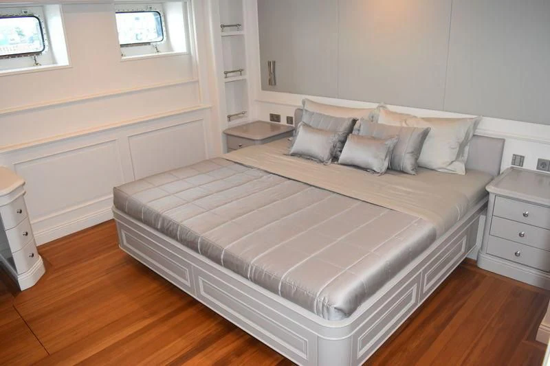 a bed with a white sheet aboard BRAVADO Yacht for Sale