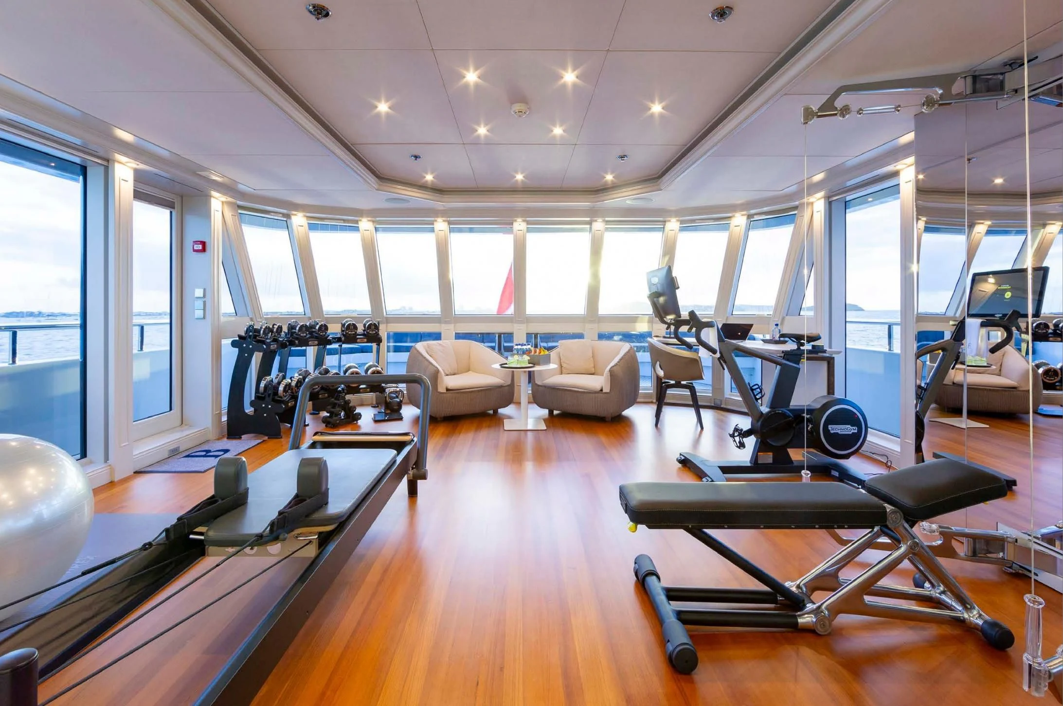 a room with a pool table and chairs aboard BRAVADO Yacht for Sale