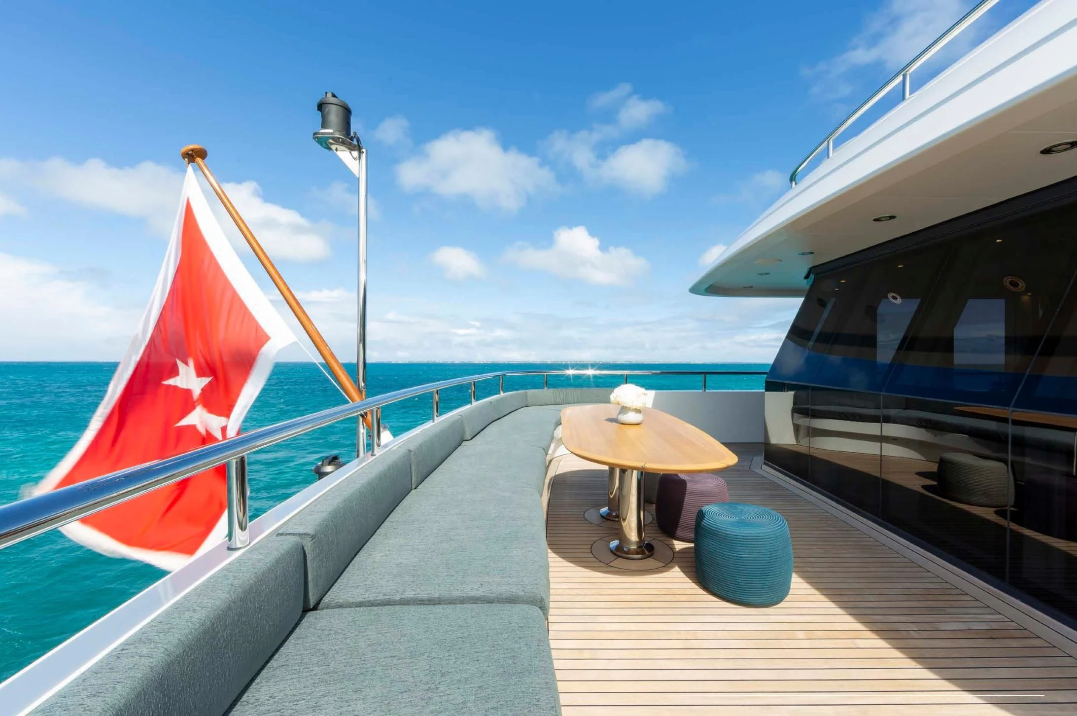 a boat with a flag on the deck aboard BRAVADO Yacht for Sale