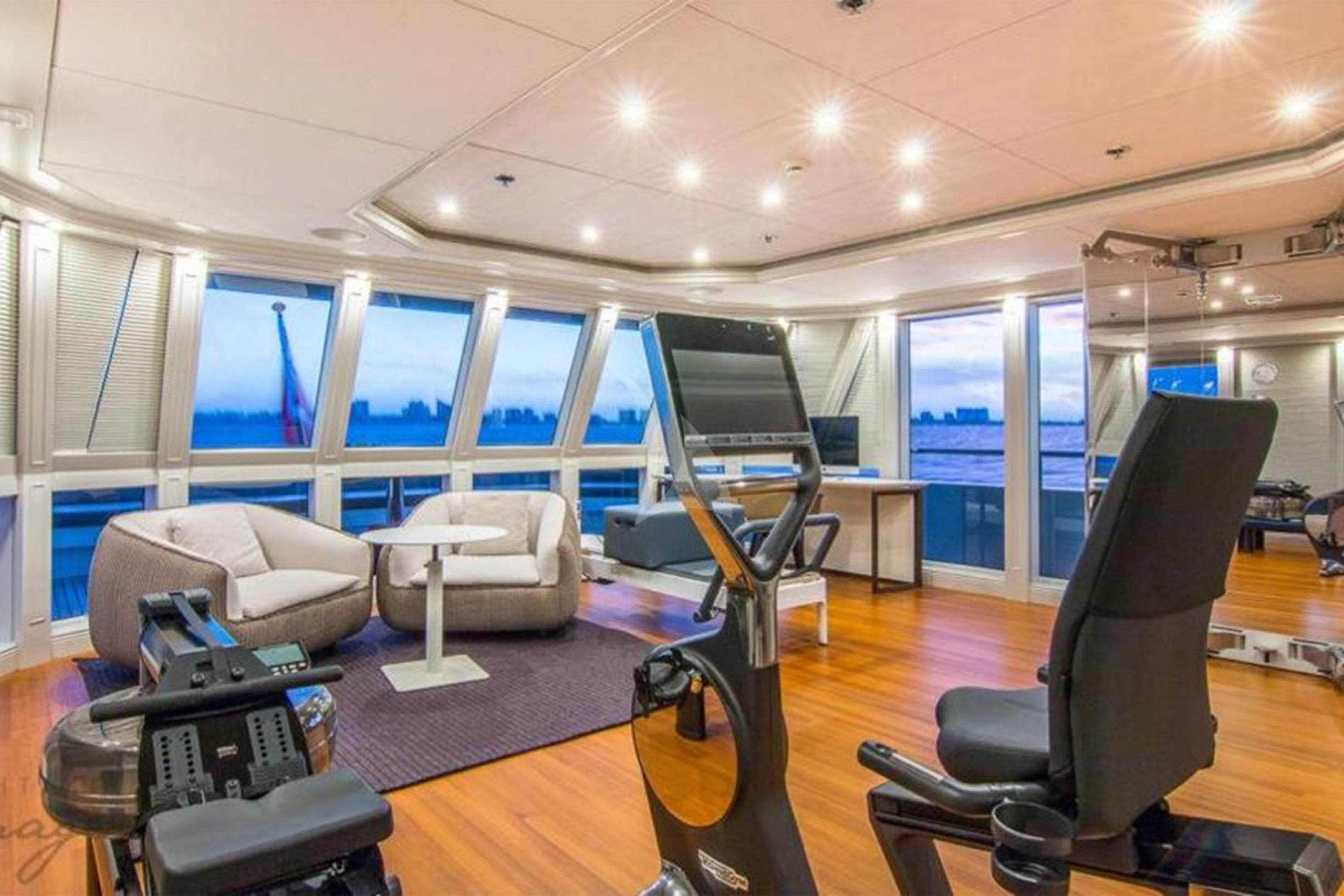 a room with treadmills and chairs aboard BRAVADO Yacht for Sale