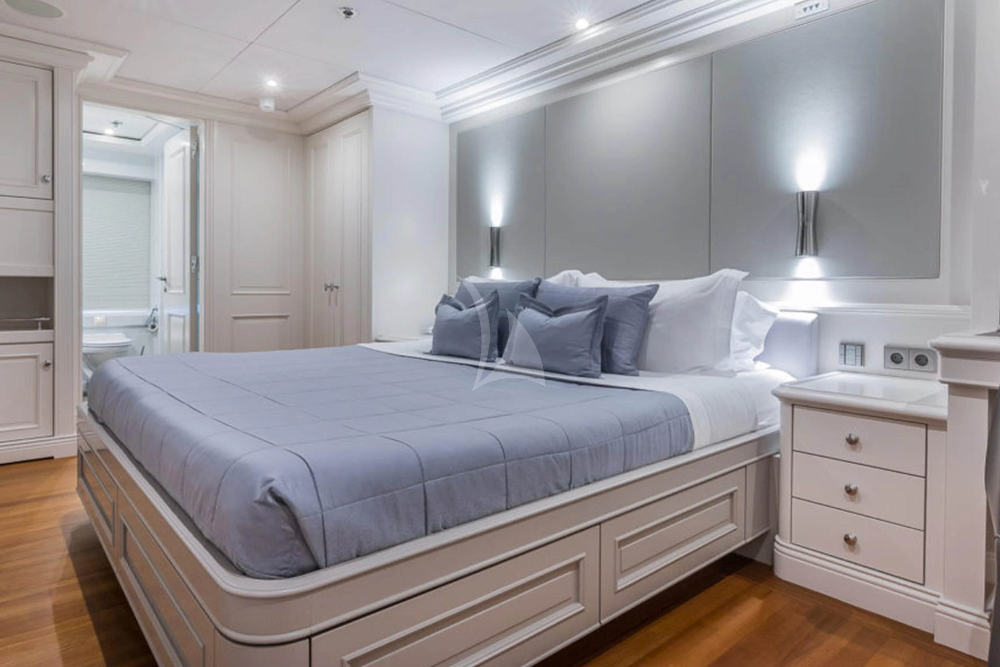 a bed with a white bed spread aboard BRAVADO Yacht for Sale
