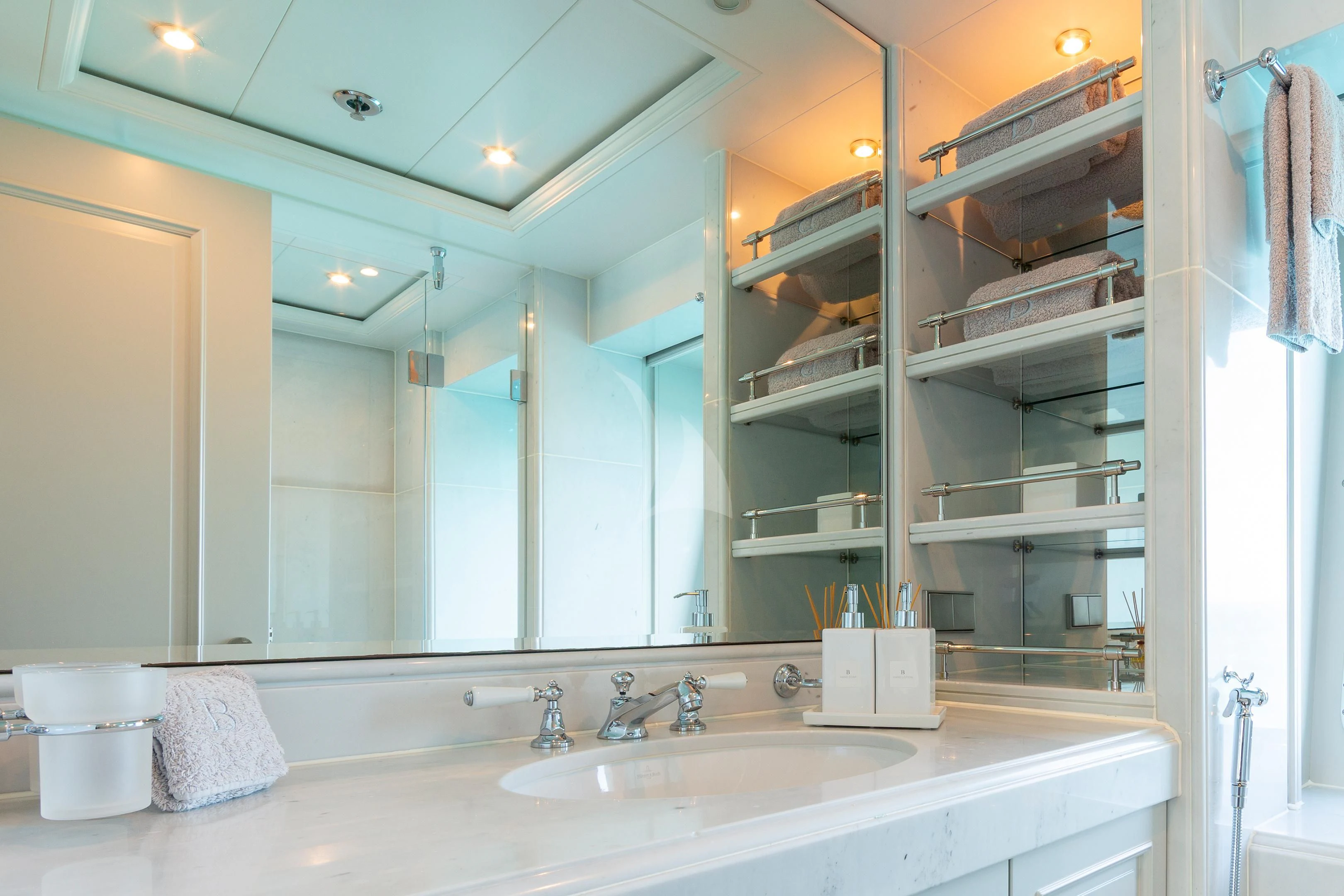 a bathroom with a large mirror aboard BRAVADO Yacht for Sale