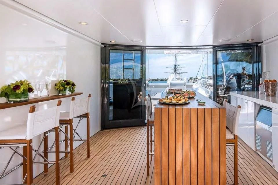 a kitchen with a table and chairs aboard BRAVADO Yacht for Sale