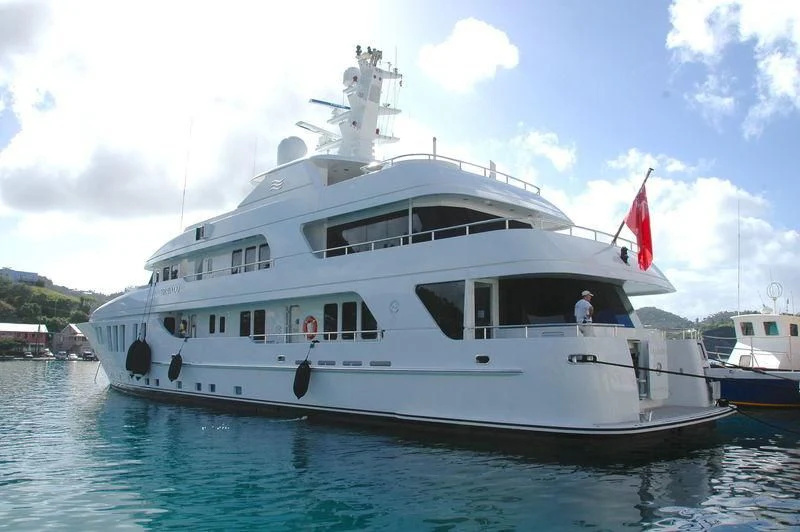 a large white boat with a flag on it aboard BRAVADO Yacht for Sale