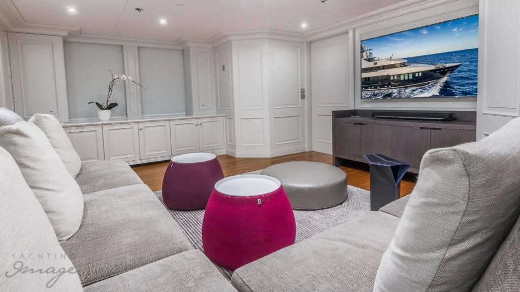 a living room with a large screen aboard BRAVADO Yacht for Sale