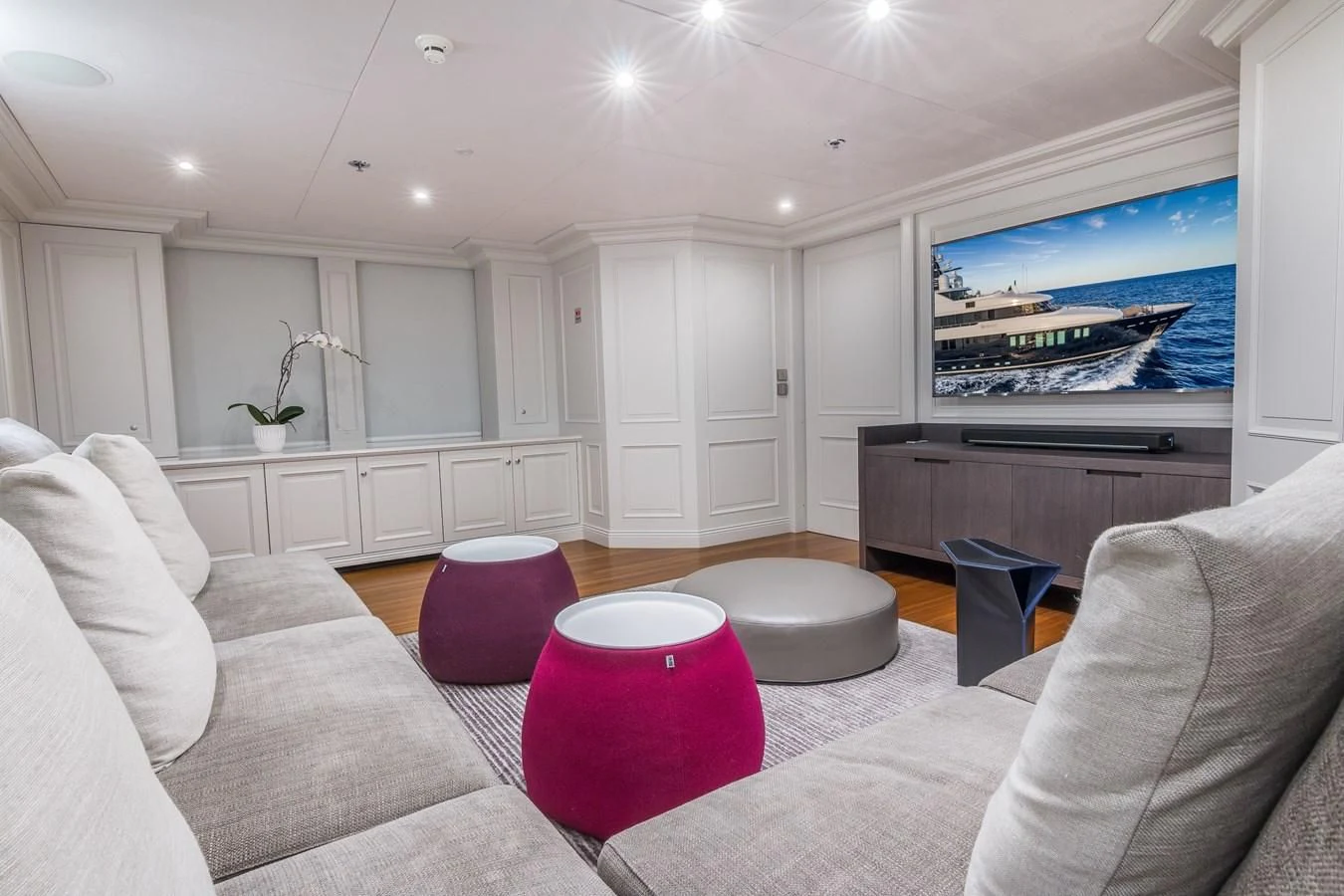 a living room with a large screen aboard BRAVADO Yacht for Sale