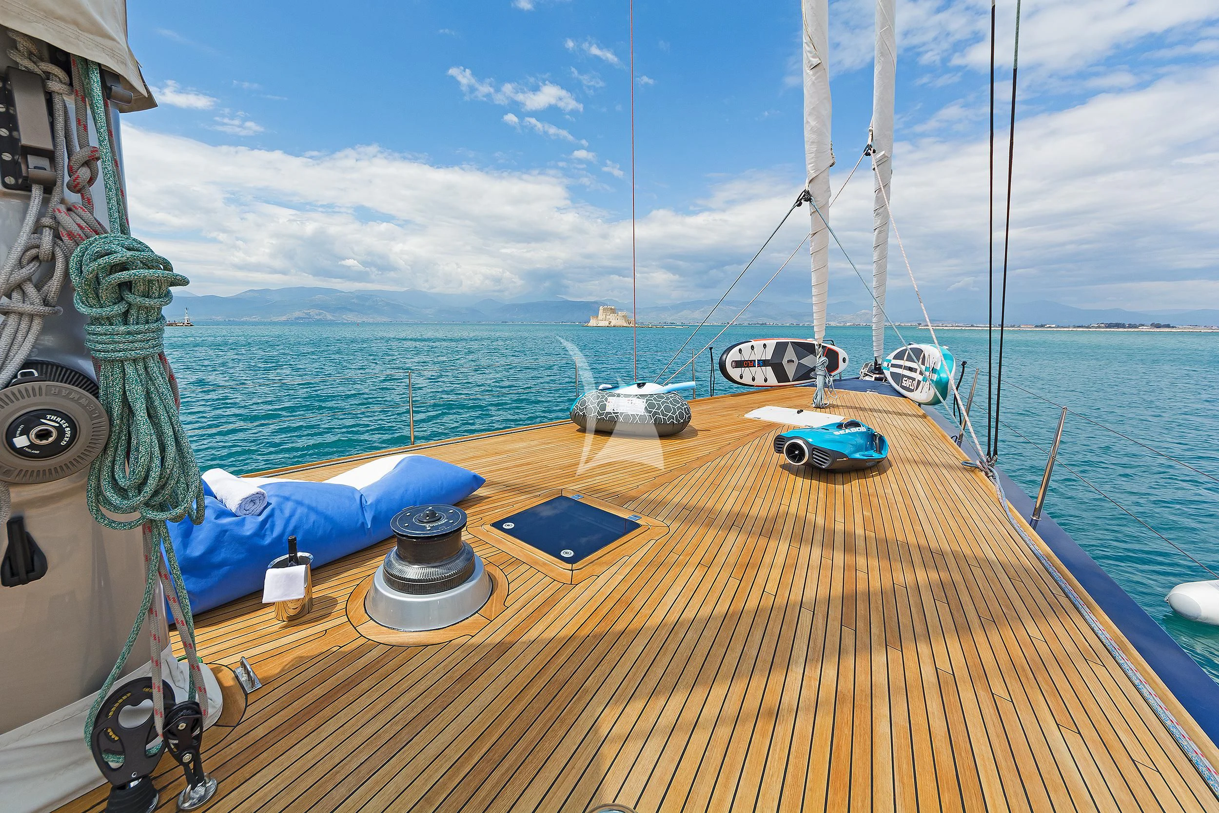 a deck with a boat and a sailboat on it aboard MELITI Yacht for Sale