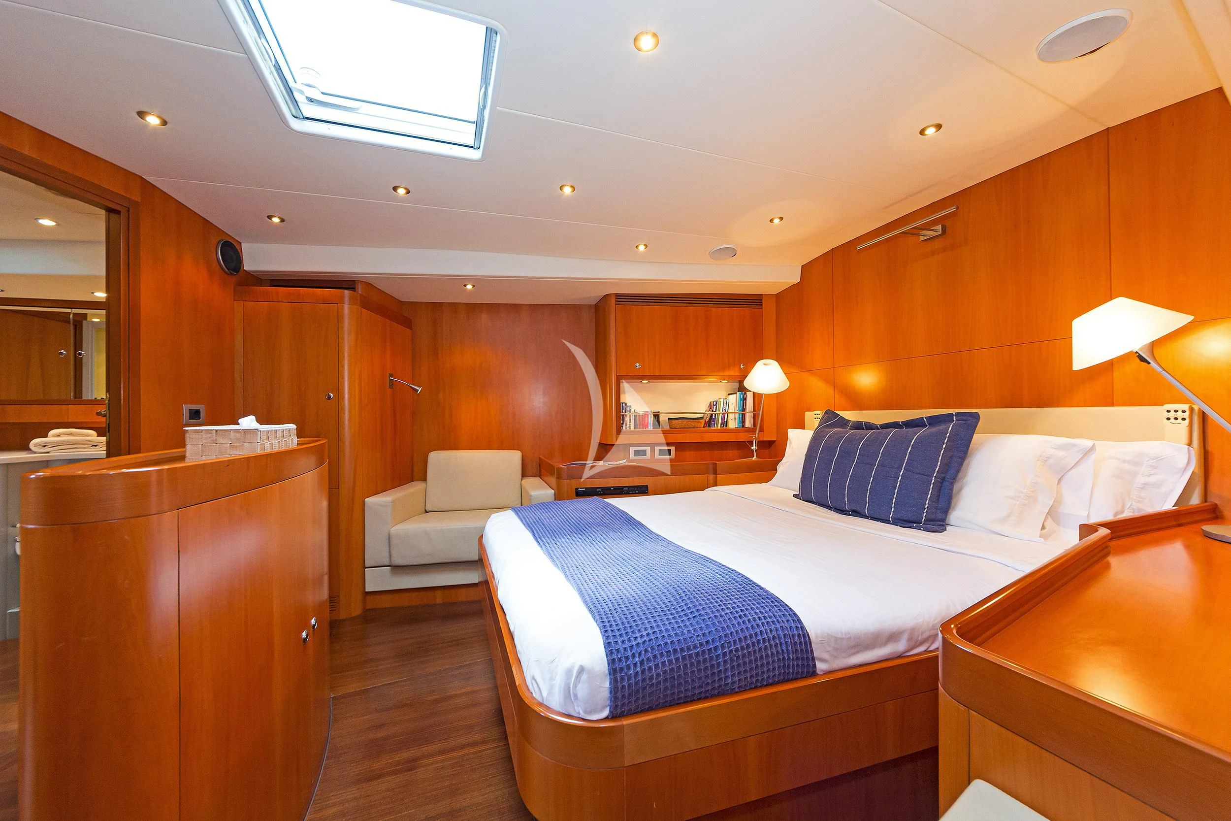 a bedroom with a bed and a desk aboard MELITI Yacht for Sale