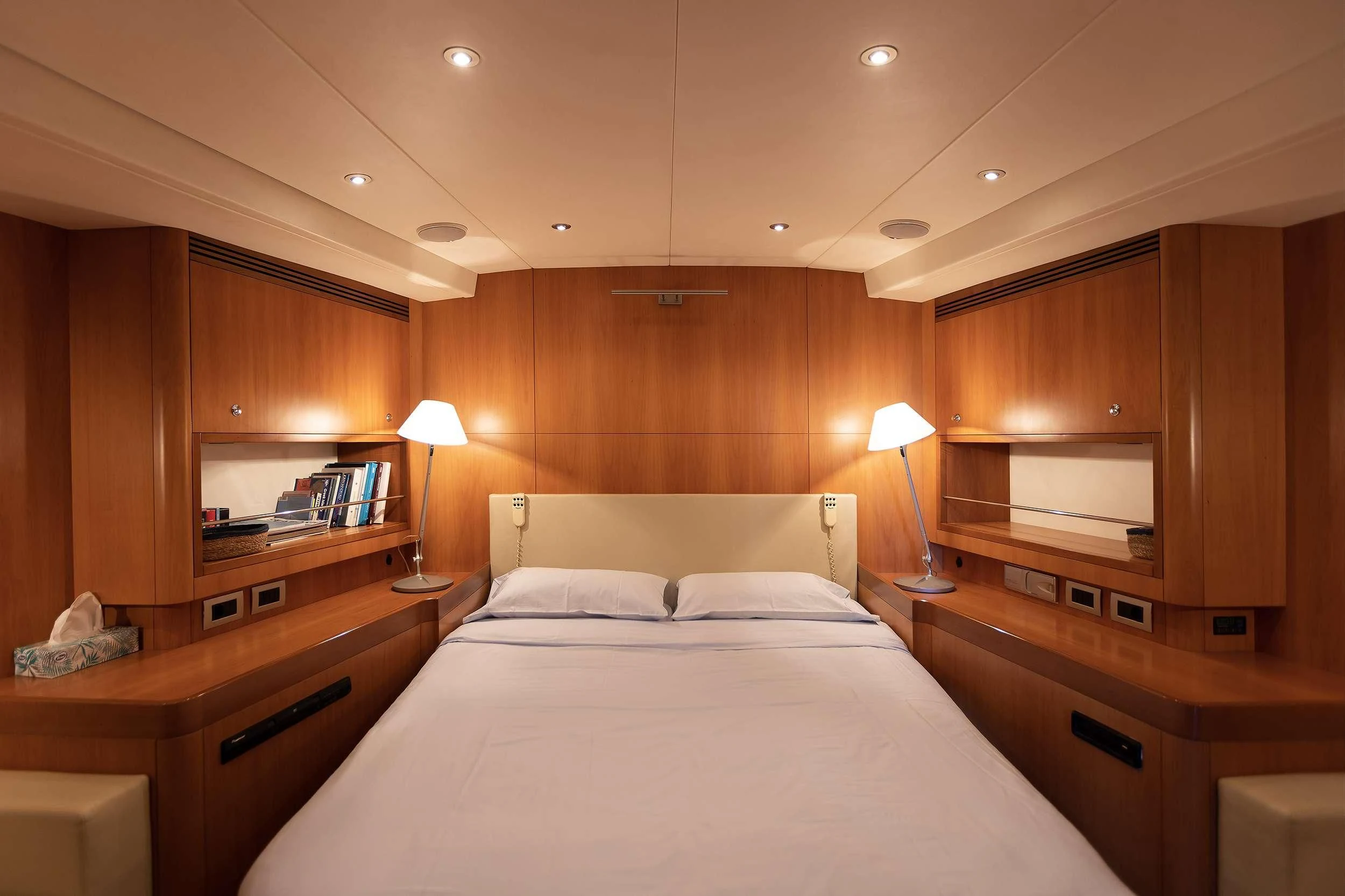 a bedroom with a bed and a desk aboard MELITI Yacht for Sale