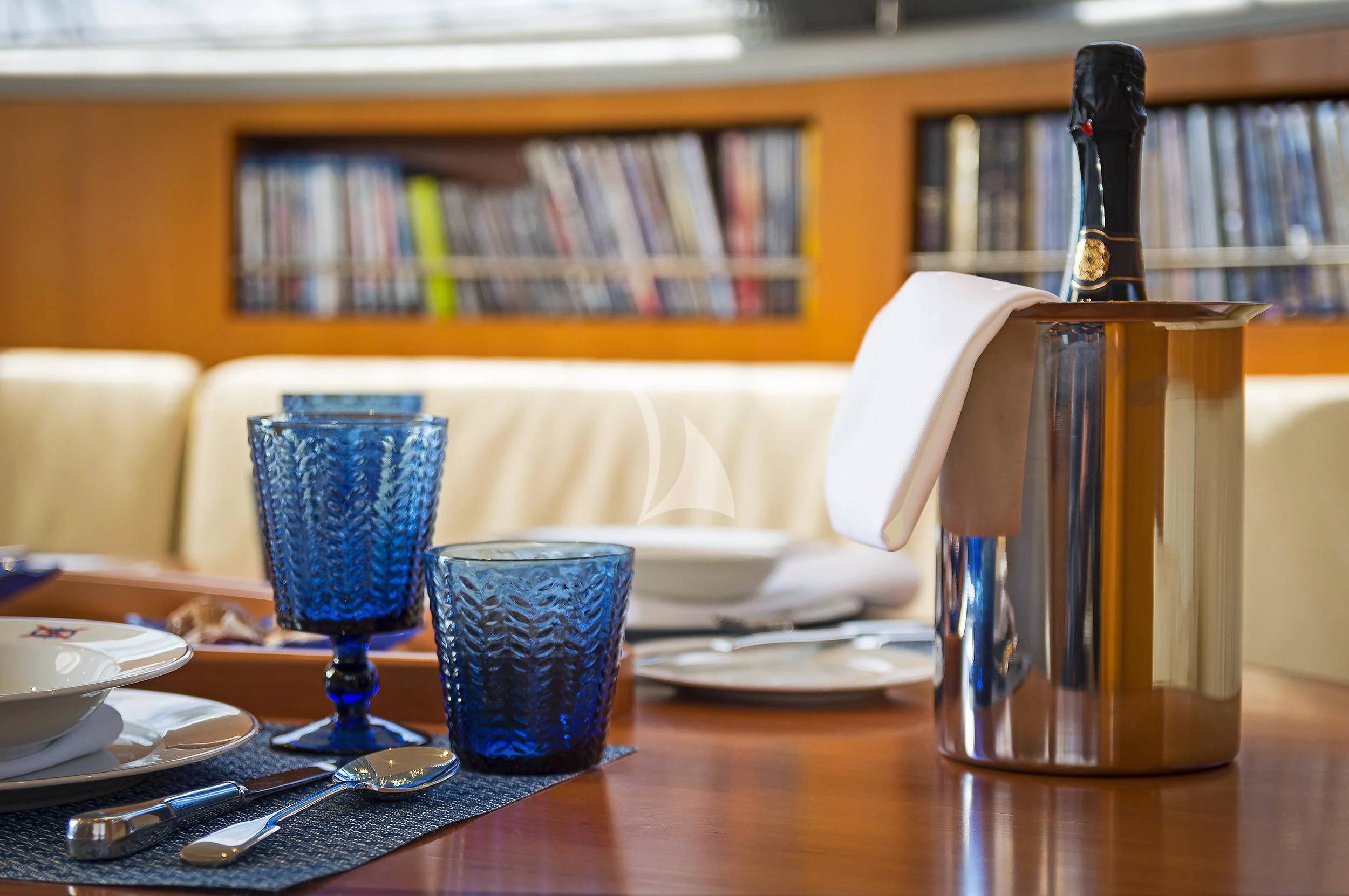 a glass bottle on a table aboard MELITI Yacht for Sale