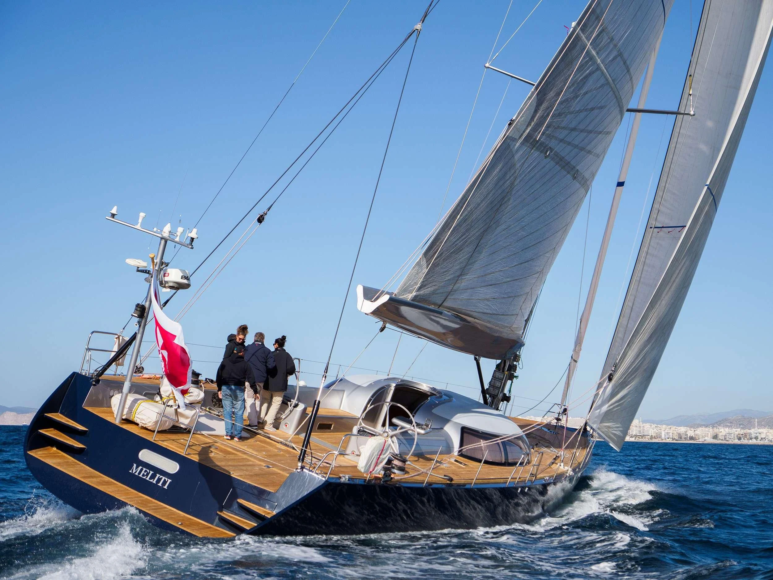 a sailboat with a flag on the front aboard MELITI Yacht for Sale