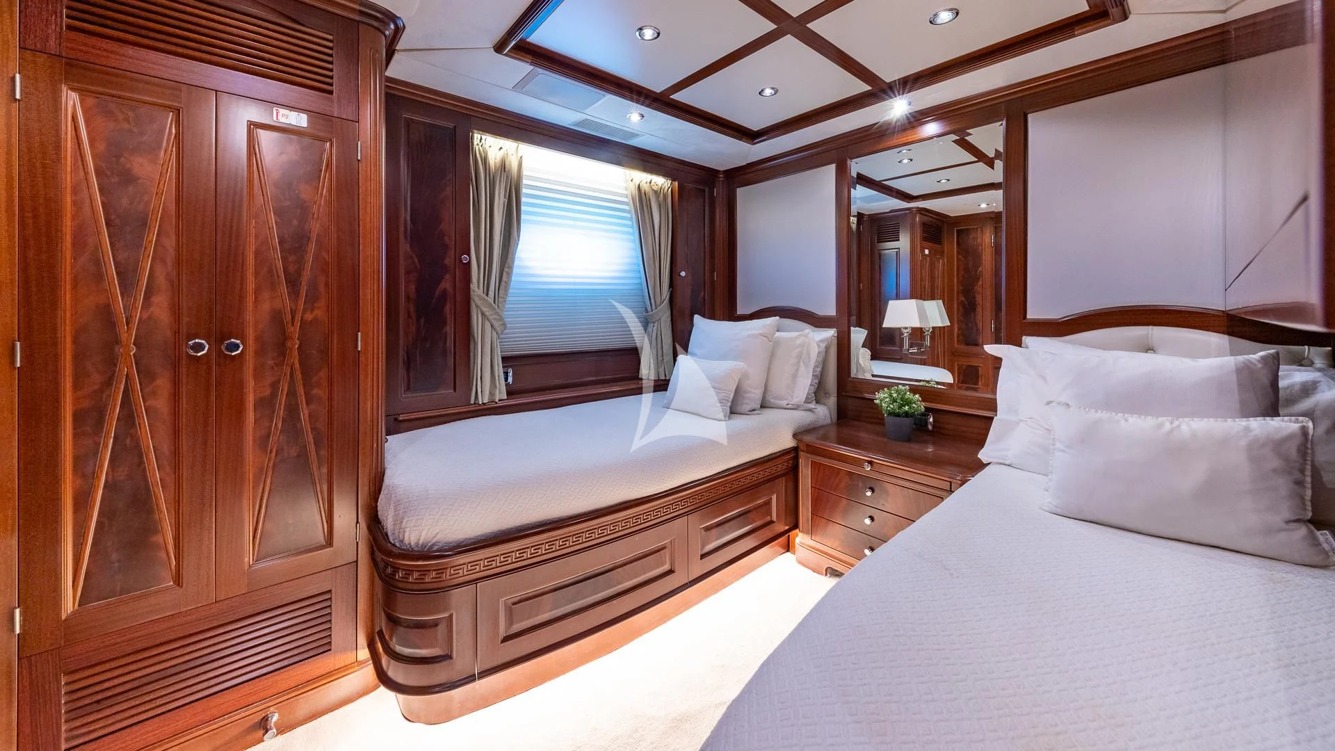 a room with a bed and a wood cabinet aboard VIRTUE Yacht for Sale
