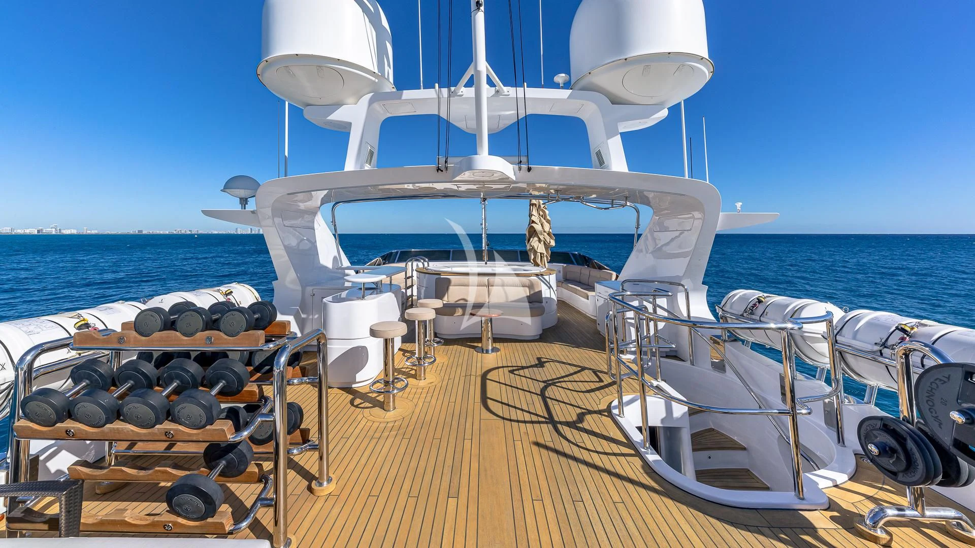 a deck with chairs on it and a body of water in the background aboard VIRTUE Yacht for Sale