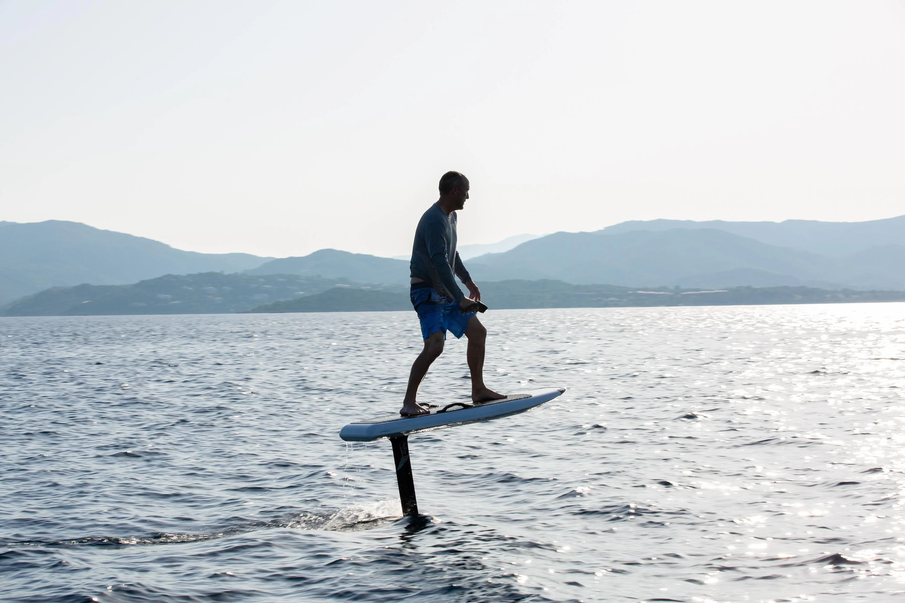 a man on a surfboard in the water aboard VIRTUE Yacht for Sale