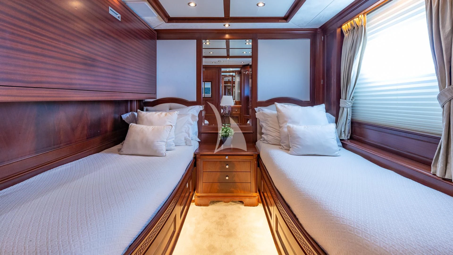 a room with a bed and a dresser aboard VIRTUE Yacht for Sale