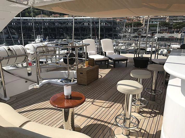 a boat with tables and chairs aboard VIRTUE Yacht for Sale