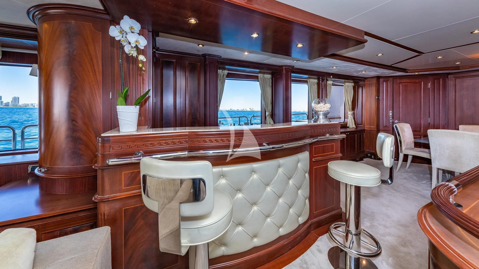 a room with a table chairs and a window aboard VIRTUE Yacht for Sale