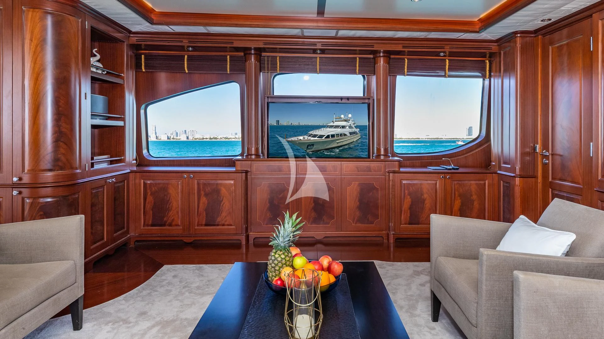 a room with a couch and a table and a window aboard VIRTUE Yacht for Sale