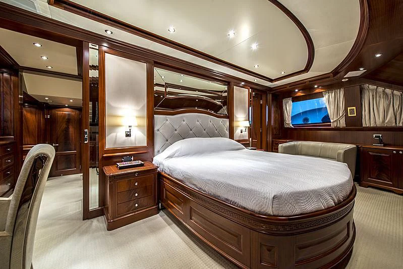 a bedroom with a bed and a tv aboard VIRTUE Yacht for Sale