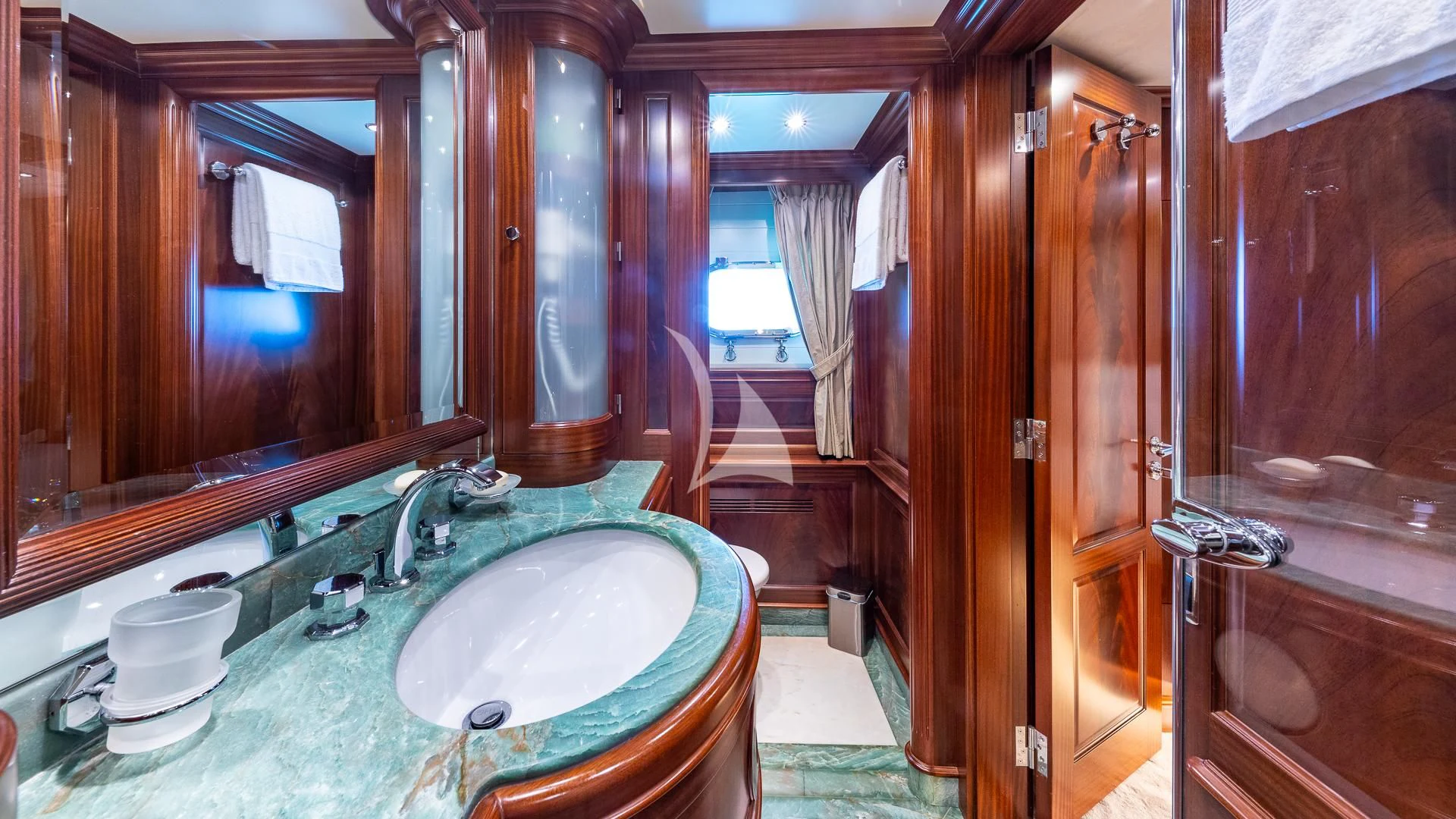 a bathroom with a sink and a large mirror aboard VIRTUE Yacht for Sale