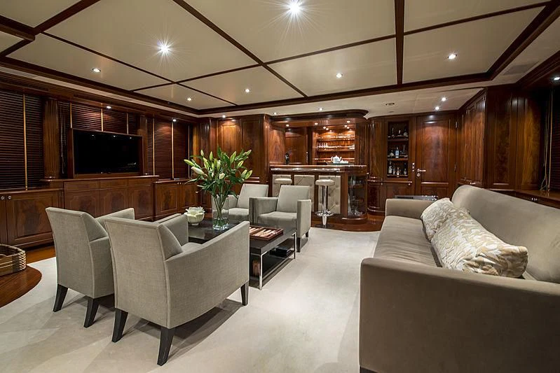 a living room with a couch and a fireplace aboard VIRTUE Yacht for Sale