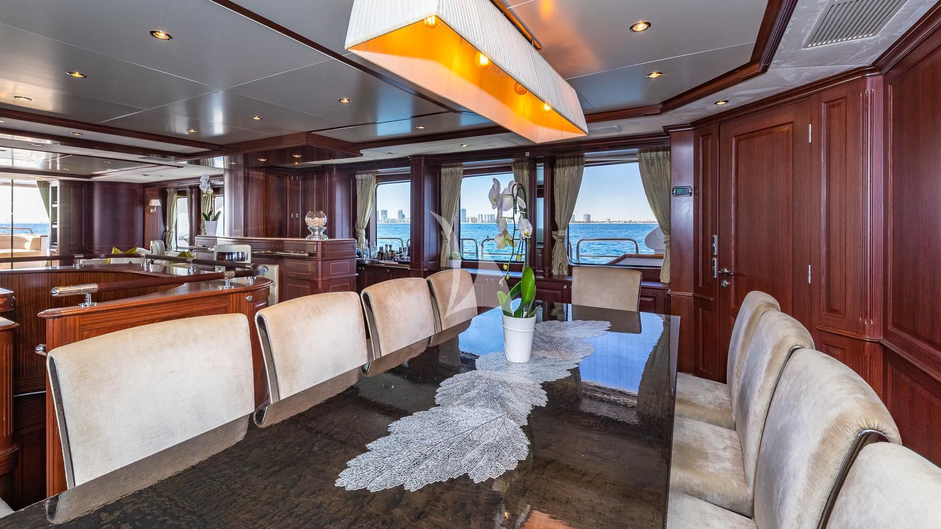 a room with a table chairs and a plant in it aboard VIRTUE Yacht for Sale