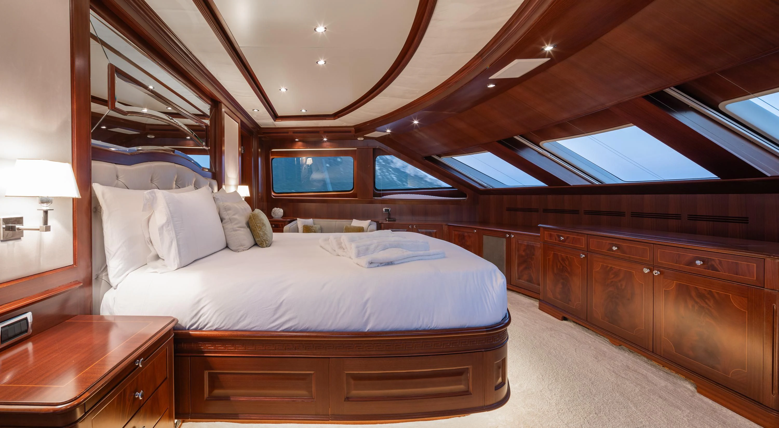 a bedroom with a bed and a wood headboard aboard VIRTUE Yacht for Sale