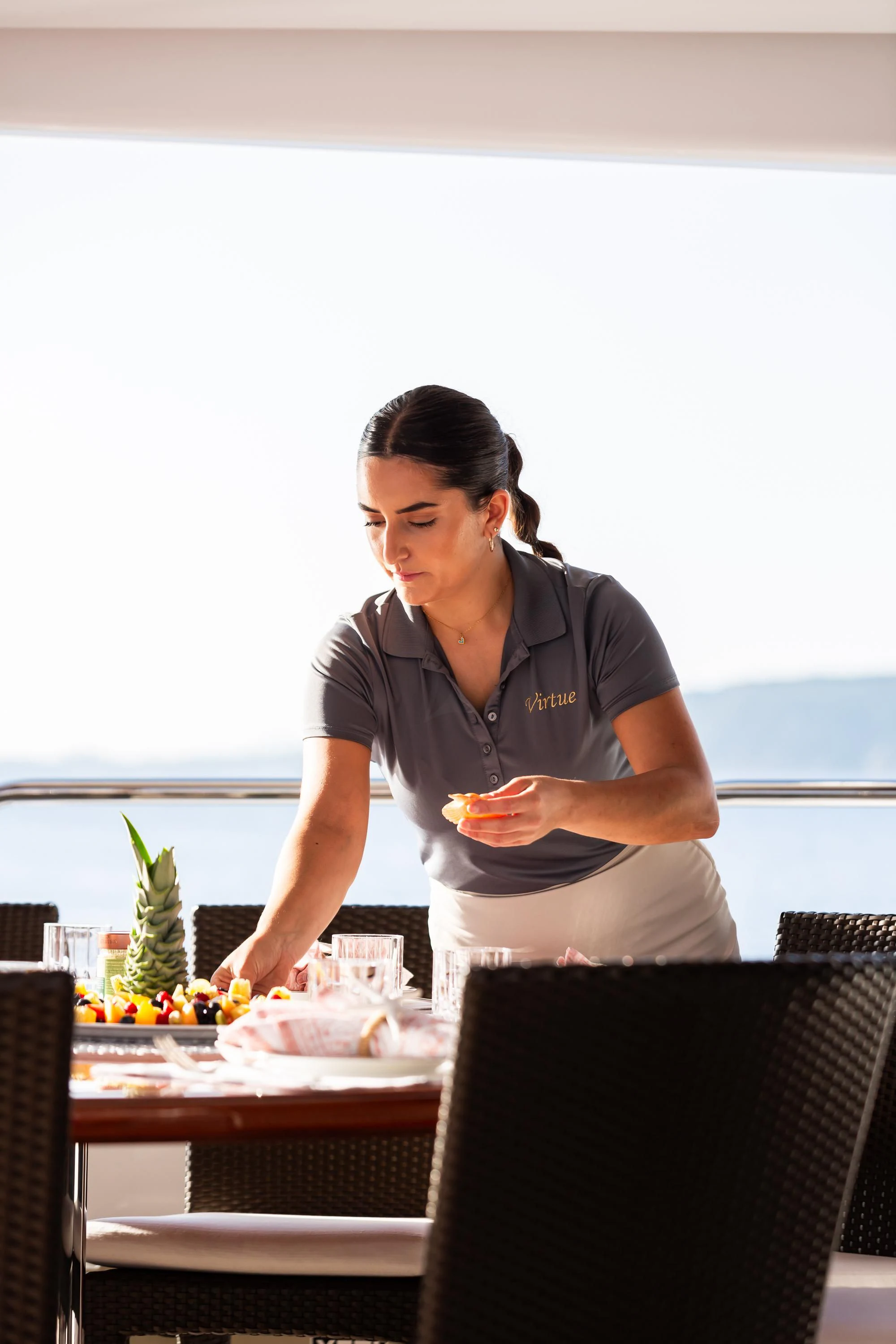 a person holding a drink aboard VIRTUE Yacht for Sale