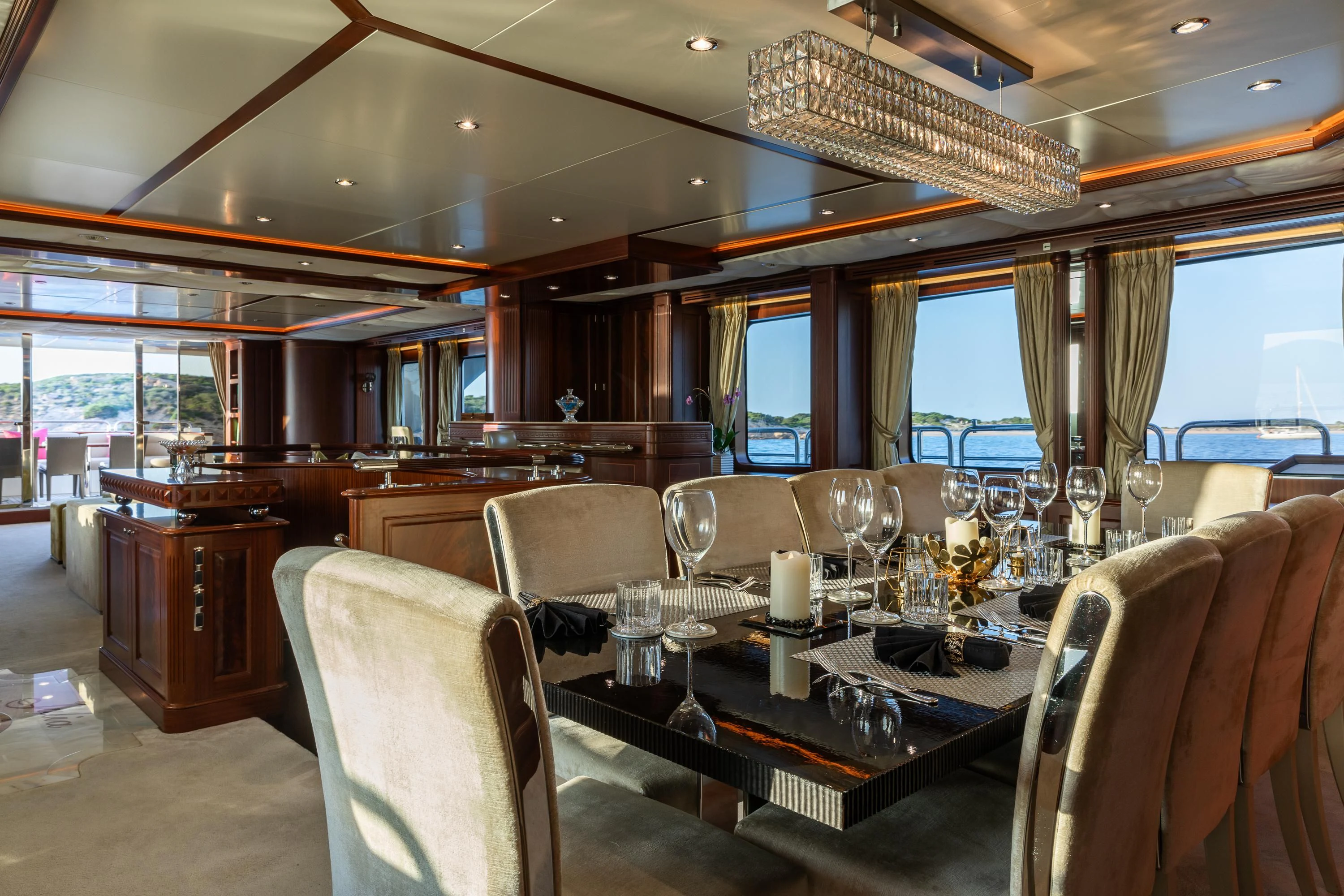 a dining room with a table set for a dinner aboard VIRTUE Yacht for Sale