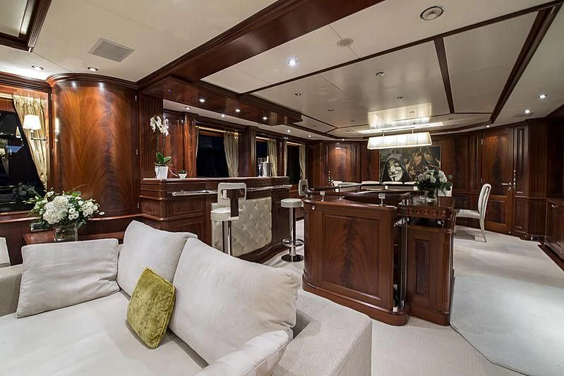 a living room with a couch and piano aboard VIRTUE Yacht for Sale