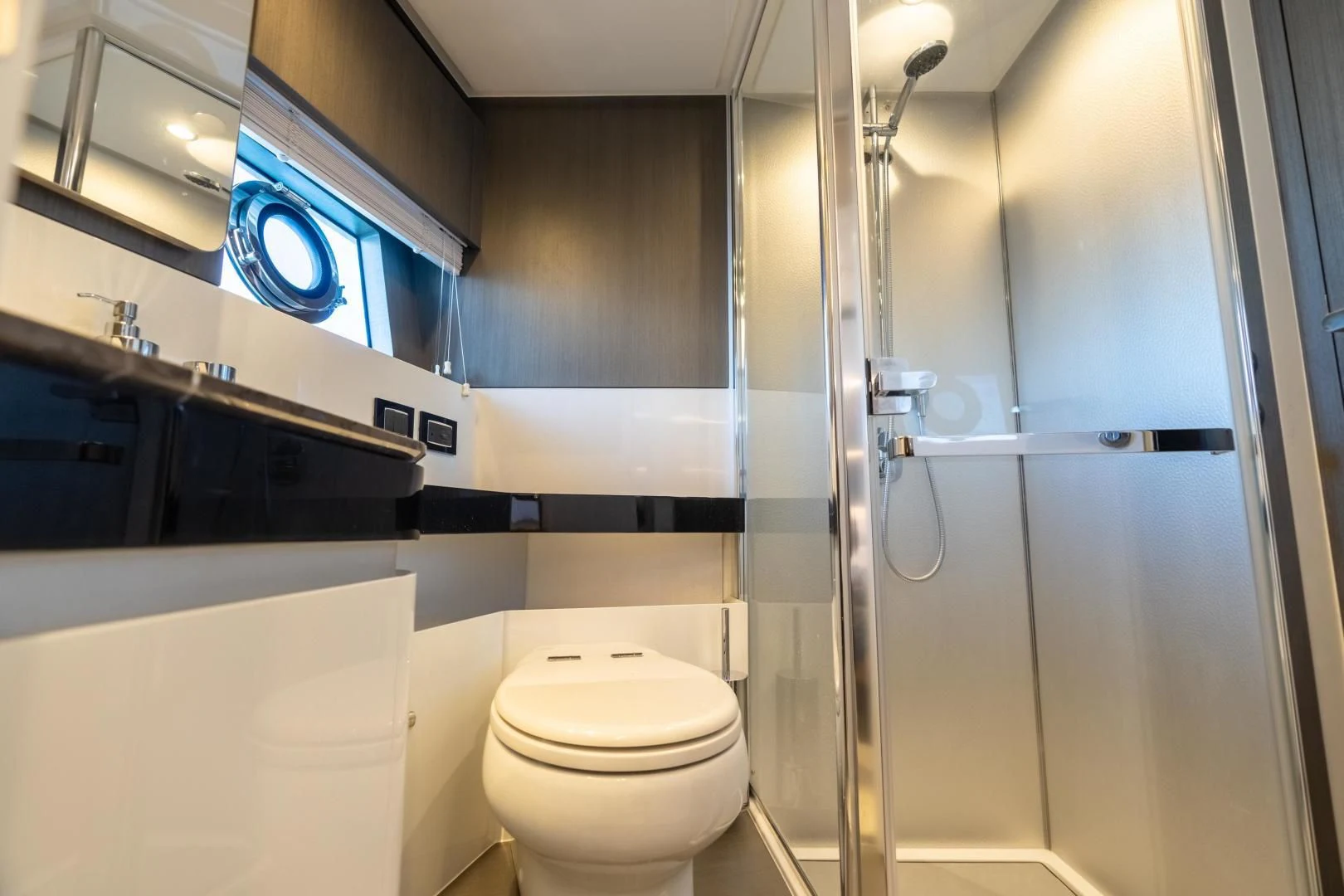 a bathroom with a toilet and a shower unit aboard ZERO DIMENSION Yacht for Sale