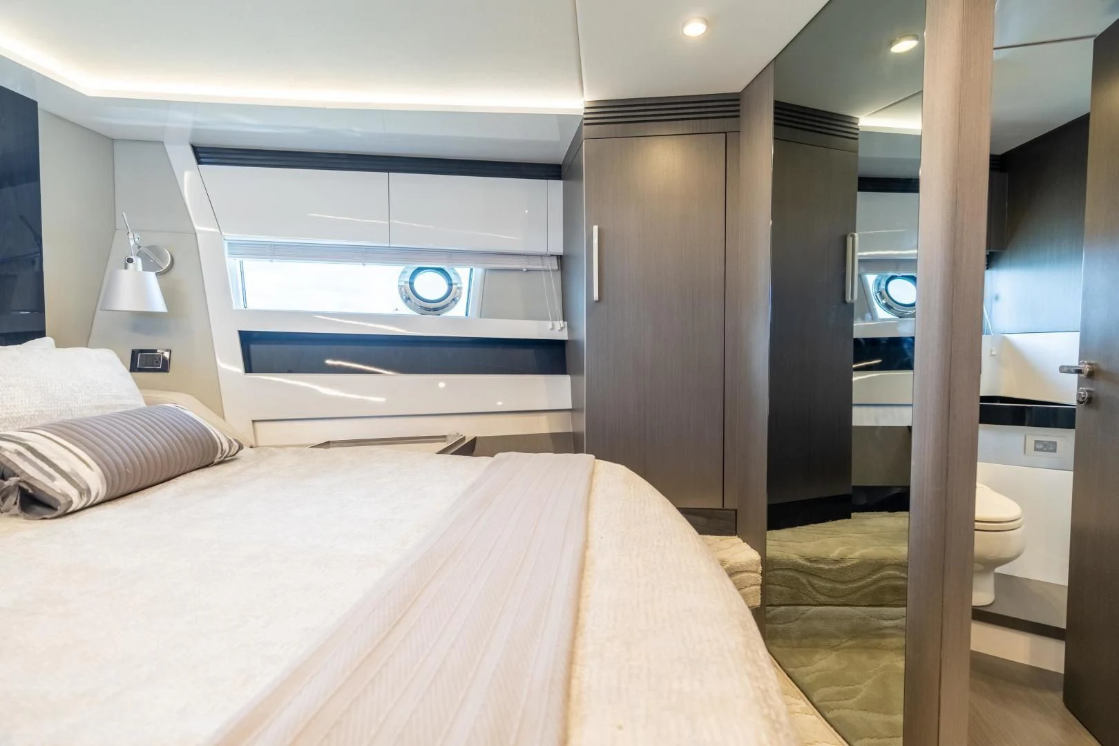a bedroom with a bed and a large mirror aboard ZERO DIMENSION Yacht for Sale