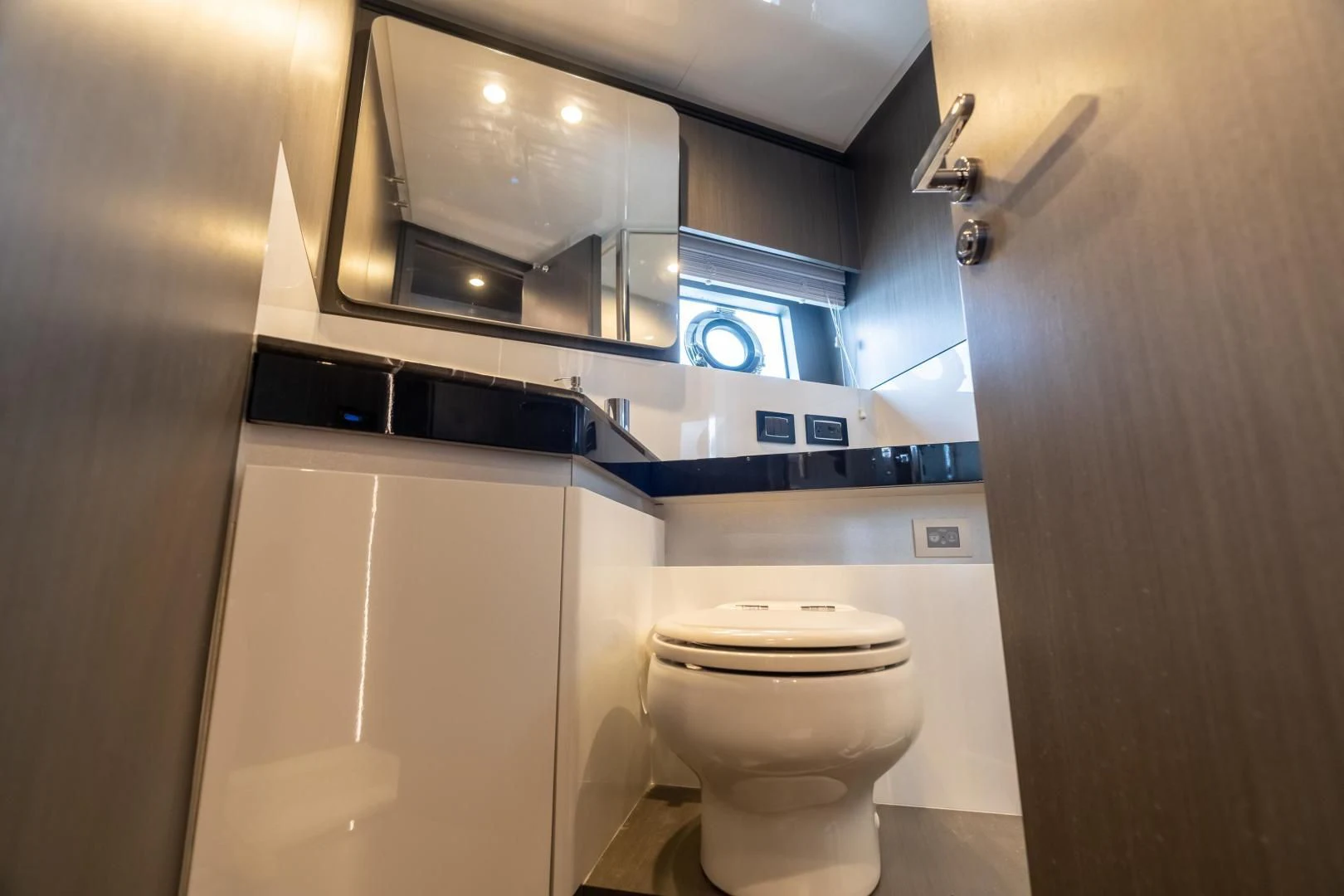 a bathroom with a toilet and a mirror aboard ZERO DIMENSION Yacht for Sale