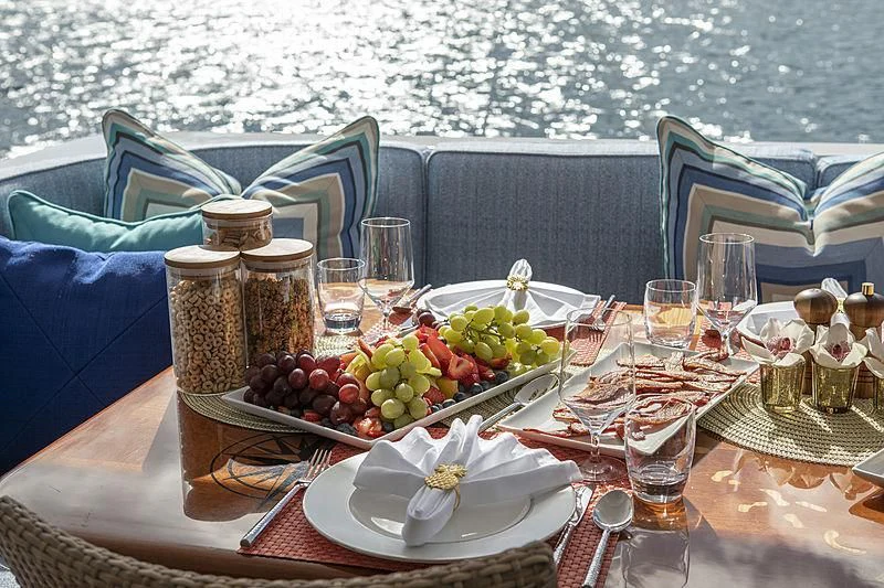 a table with food and glasses on it aboard WINNING HAND Yacht for Sale
