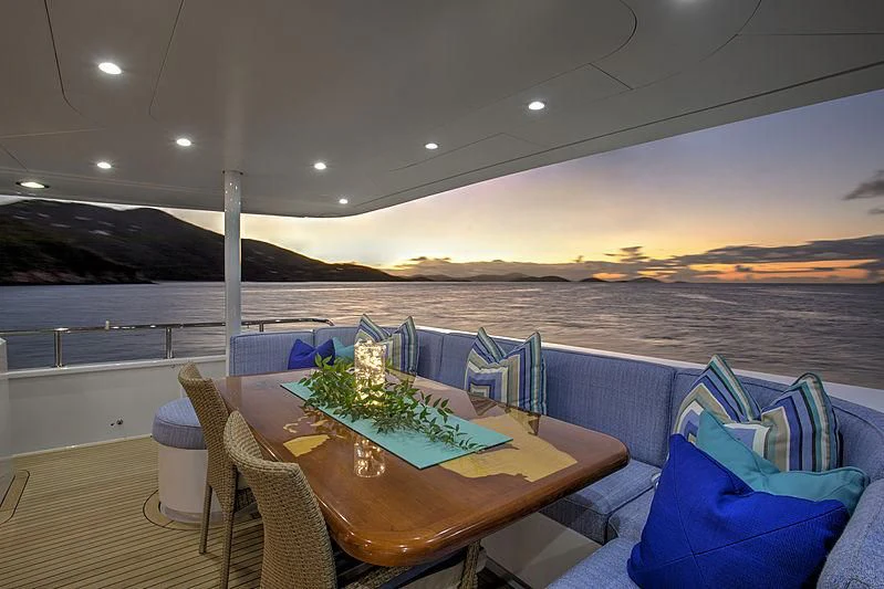 a table with chairs and a view of a body of water aboard WINNING HAND Yacht for Sale