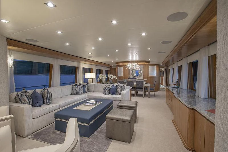 a living room with a large sofa aboard WINNING HAND Yacht for Sale