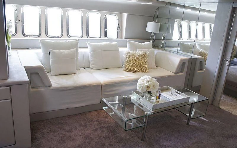 a living room with a white couch aboard JUST FOR FUN 88 Yacht for Sale