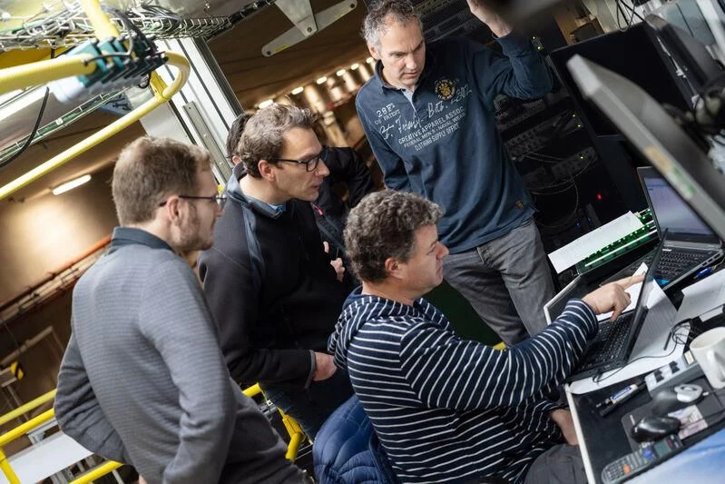a group of men looking at computers aboard PROJECT SETTEESETTANTA Yacht for Sale