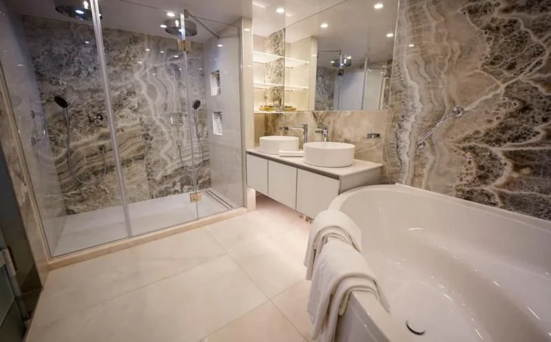 a bathroom with a large glass shower aboard FREEDOM Yacht for Sale