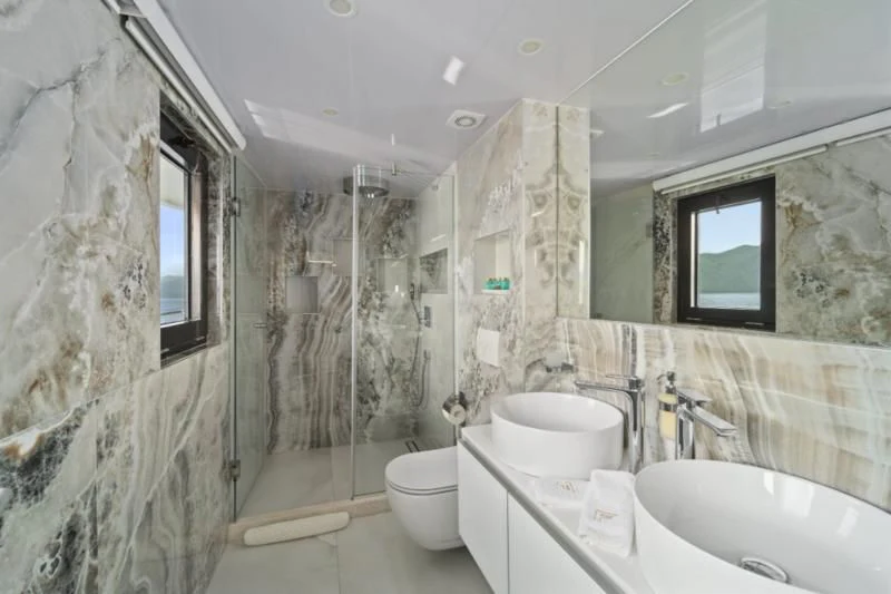 a bathroom with a sink toilet and a bathtub aboard FREEDOM Yacht for Sale