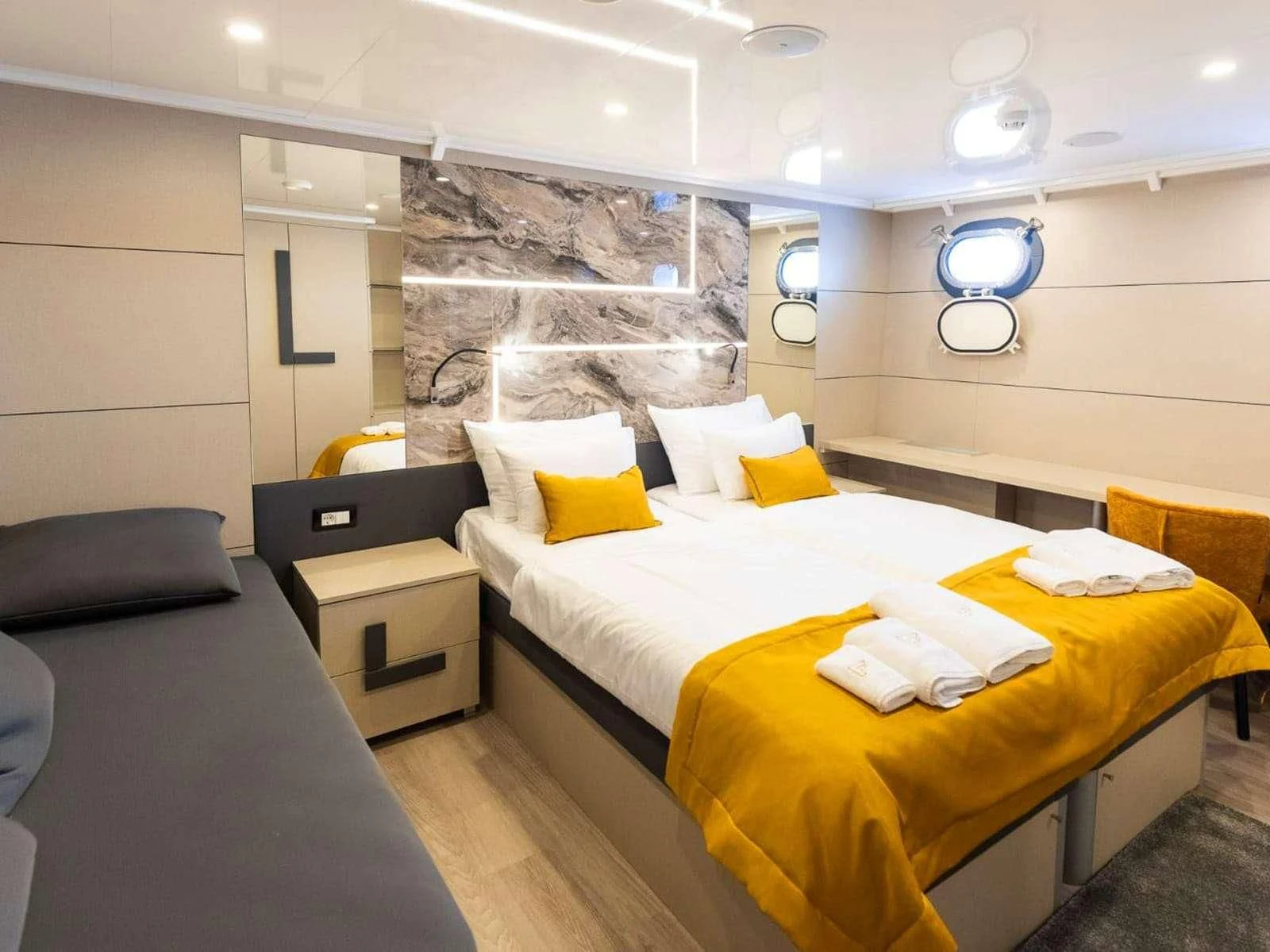 a bedroom with a bed and a desk aboard FREEDOM Yacht for Sale