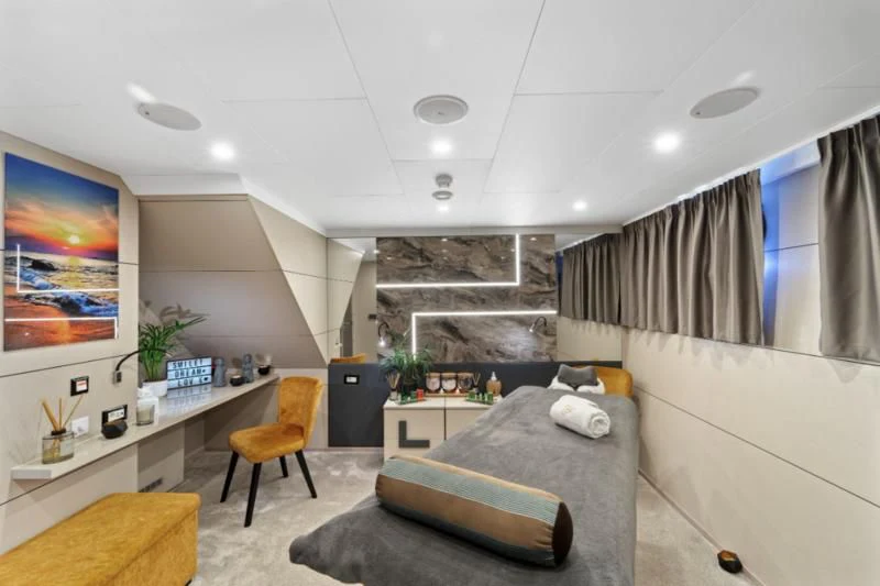 a living room with a couch and a table aboard FREEDOM Yacht for Sale