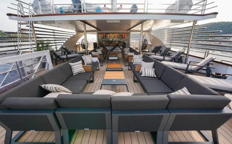 a large room with a large deck aboard FREEDOM Yacht for Sale
