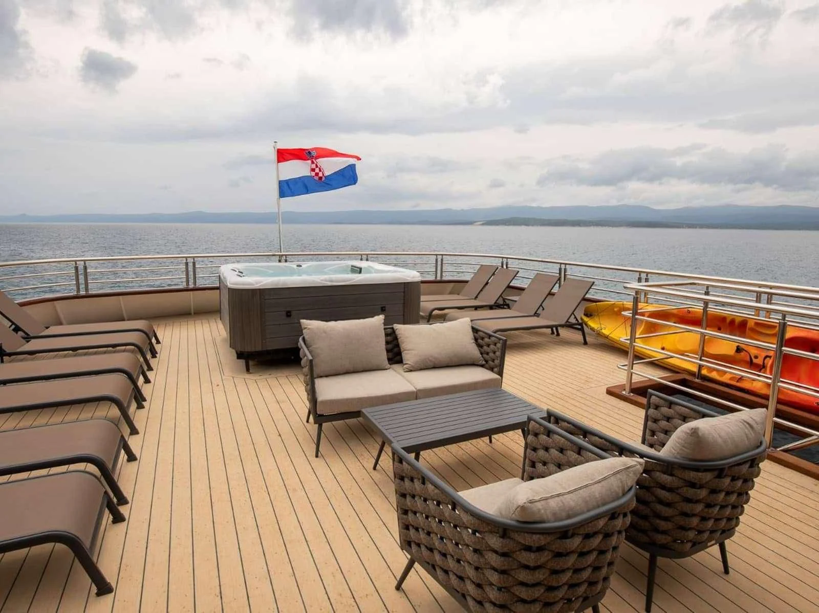 a deck with chairs and a table on it aboard FREEDOM Yacht for Sale