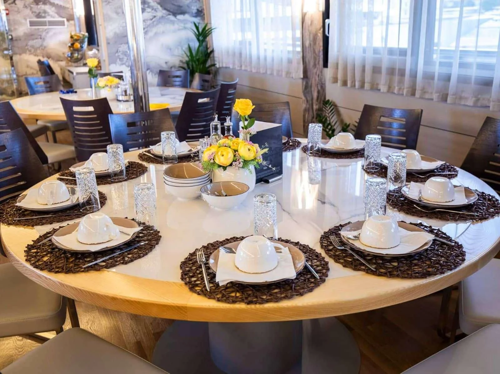 a table set with plates and glasses aboard FREEDOM Yacht for Sale