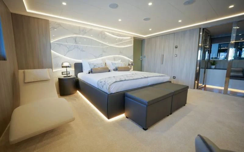 a large room with a bed and a desk aboard FREEDOM Yacht for Sale