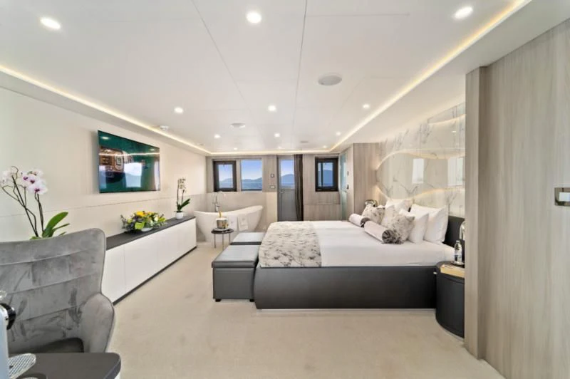 a bedroom with a bed and a tv aboard FREEDOM Yacht for Sale