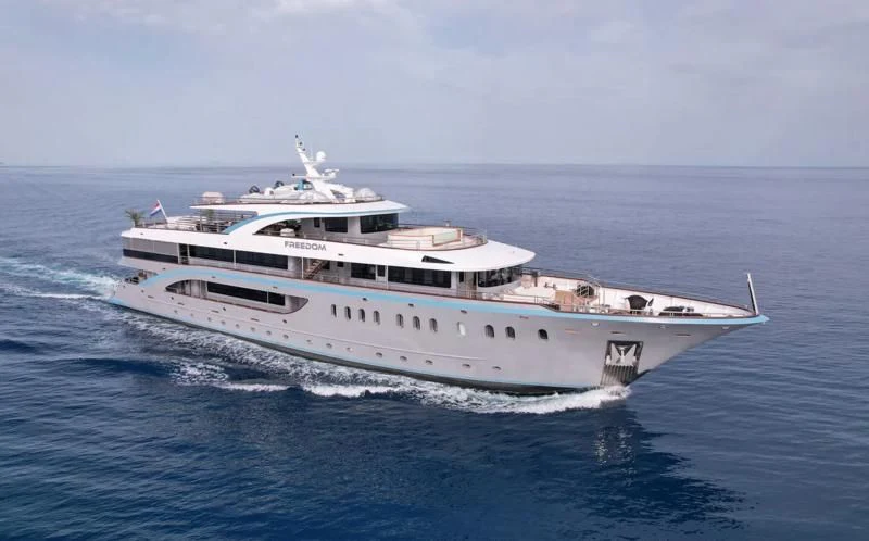a large white boat in the water aboard FREEDOM Yacht for Sale