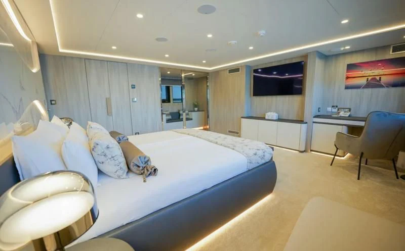 a large bedroom with a bed aboard FREEDOM Yacht for Sale